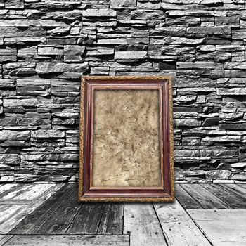 vintage black and white interior of a room with a stone wall with wooden floors and old frame