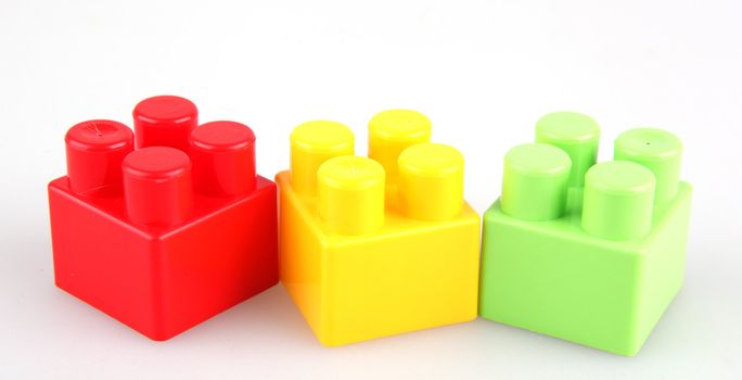 Plastic toy blocks on white background