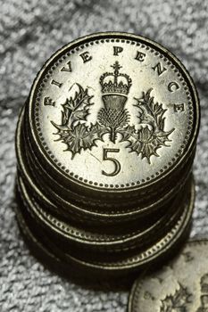 A pile of five pence coins