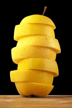 Yellow apple tower on a black background. Clipping paths are included