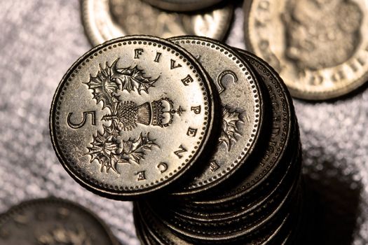 A pile of five pence coins