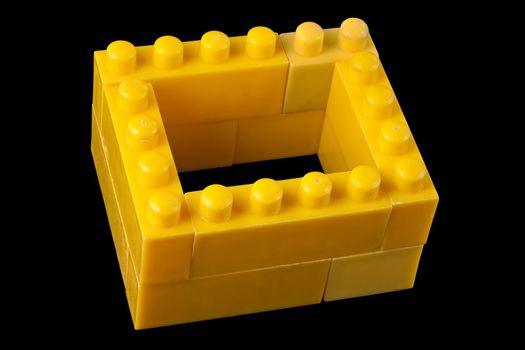 Yellow lego bricks on a black background. Clipping path is included