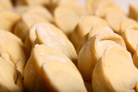 hand made ravioli getting prepared on table waiting for cooking