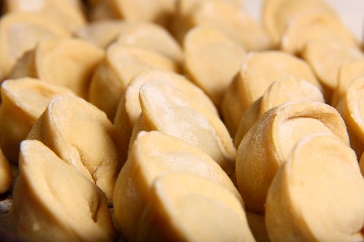 hand made ravioli getting prepared on table waiting for cooking