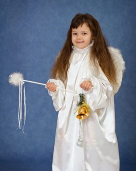 A child dressed as an angel with a magic wand and bells