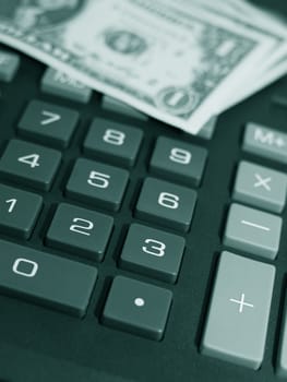 Money on keypad of a calculator close up