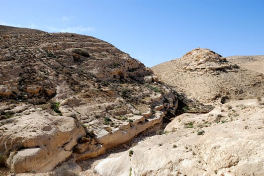 Ancient rocks under blue sky. Desert Negev, Israel.