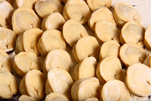 hand made ravioli getting prepared on table waiting for cooking