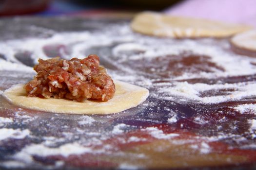 hand made ravioli getting prepared on table 