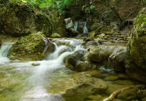 beautiful waterfall on small forest stream
