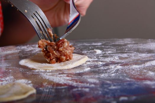 hand made ravioli getting prepared on table 