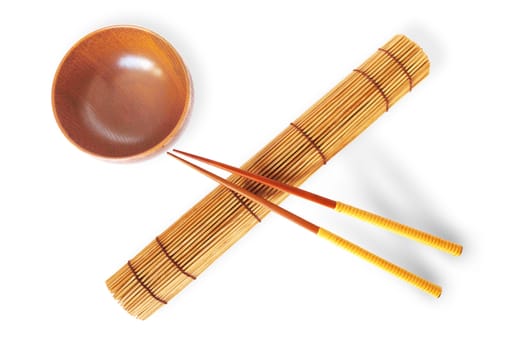 rolled bamboo mat with a pair of chopsticks  and wooden bowl 