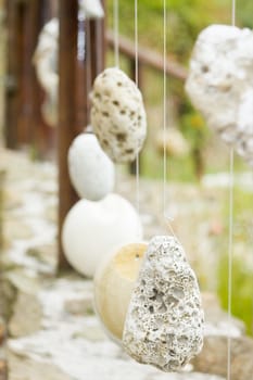 Natural wooden railing with decorative hanged stones