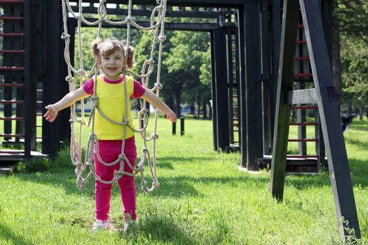 happy little girl on park playground