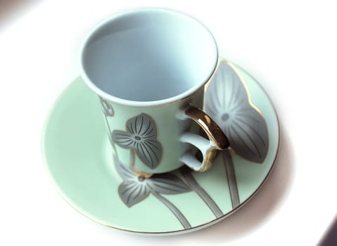 empty cup and saucer  with pattern  