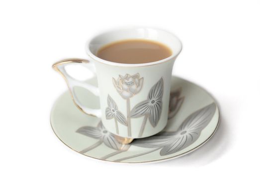 cup of coffee with milk or cream and saucer 