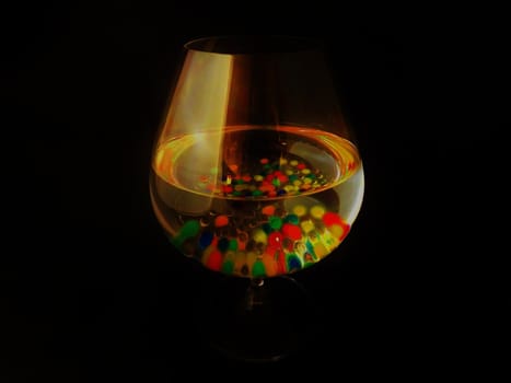 a candy cocktail with many coloured ice sweets.