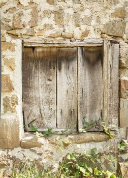 Detail of vintage old wooden gate in a stone wall