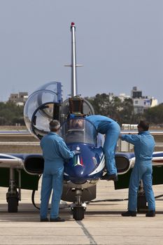 LUQA, MALTA - 25 SEP - Crew members from the Italian Frecce Tricolori aerobatic team check their aircraft before an aerial display during the Malta International Airshow on 25 September 2011