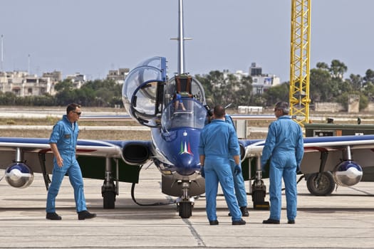 LUQA, MALTA - 25 SEP - Crew members from the Italian Frecce Tricolori aerobatic team check their aircraft before an aerial display during the Malta International Airshow on 25 September 2011