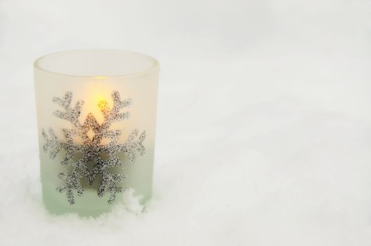 A single candlelight in the snow