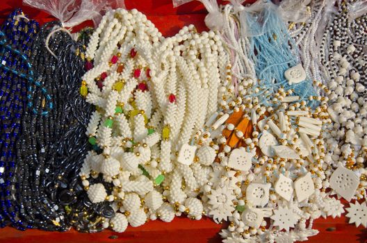 various glass and camel bone jewelry in street market, India