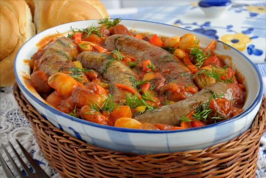 Home sausage with beans, onions and carrots in a tomato sauce