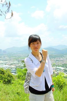 Asian girl hiking in countryside 