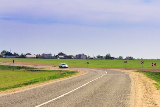 A car driving fast on a road in a countryside
