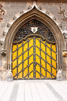 Old wooden entrance gate in a house, with iron ornaments