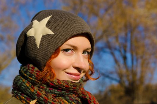 Young red woman enjoying sunny autumn day