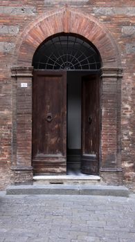 A medieval arched door in Siena, Italy.
