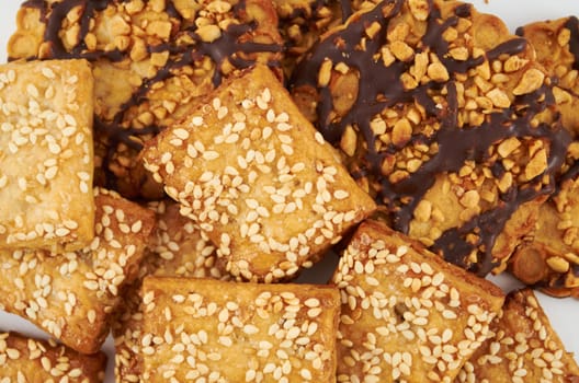 A handful of cookies with peanuts and sesame seeds