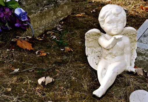 Gravesite - Cherub blowing a kiss - background