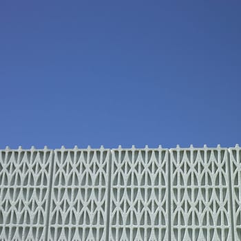 Patterned wall and blue sky