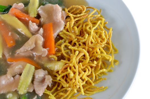 crispy yellow noodle with in a creamy gravy sauce