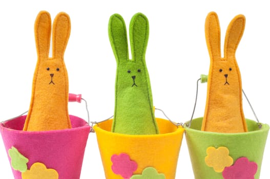 Closeup shot of multicolored easter bunnies sitting on the pots