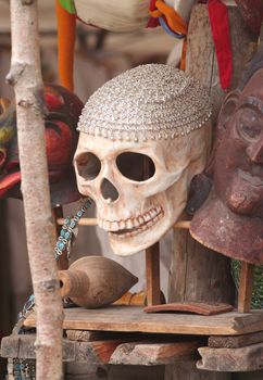 Scull for sale in a market stand among other stuff.