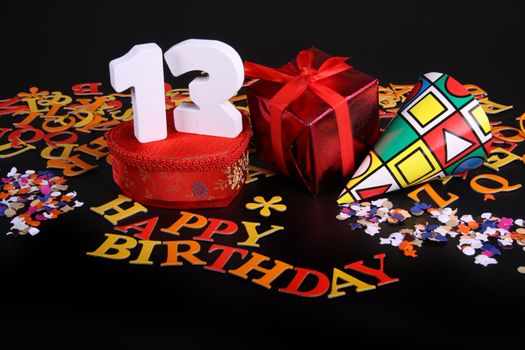 Happy birthday on a black background  and a red heart  and white caracters and confetti