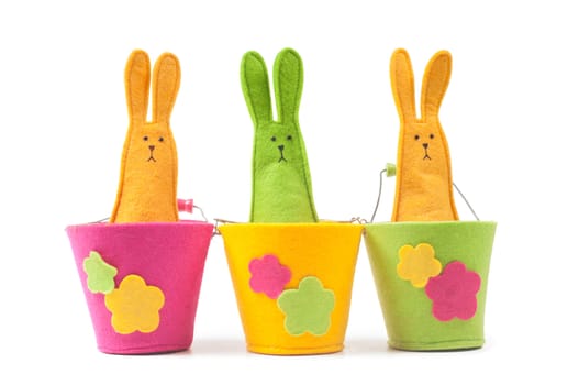 Multicolored easter bunnies sitting on the pots in row