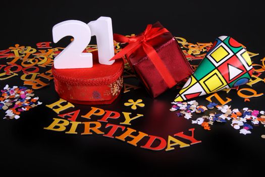 Happy birthday on a black background  and a red heart  and white caracters and confetti