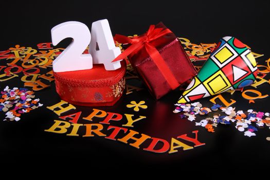 Happy birthday on a black background  and a red heart  and white caracters and confetti