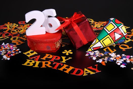 Happy birthday on a black background  and a red heart  and white caracters and confetti