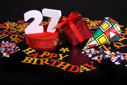 Happy birthday on a black background  and a red heart  and white caracters and confetti