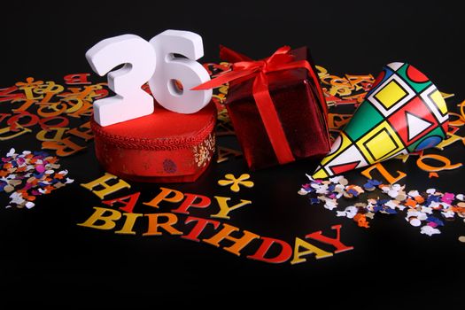 Happy birthday on a black background  and a red heart  and white caracters and confetti