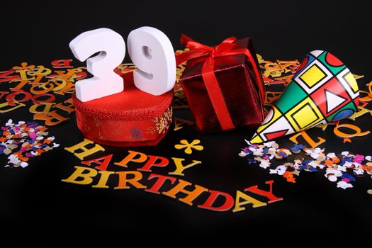 Happy birthday on a black background  and a red heart  and white caracters and confetti