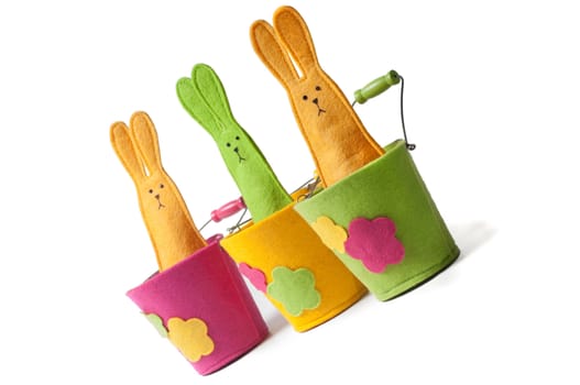 Multicolored easter bunnies sitting on the pots