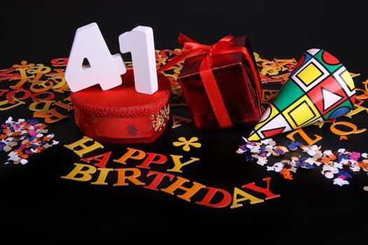 Happy birthday on a black background  and a red heart  and white caracters and confetti