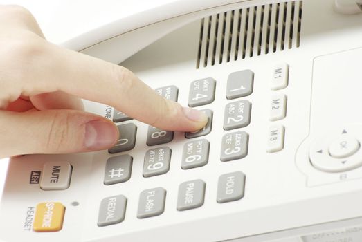 finger with  white telephone keypad