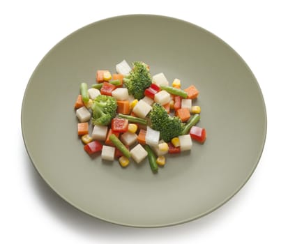 Vegetable mix with potato, paprika, kidney bean, corn, carrot, onion and broccoli on the plate